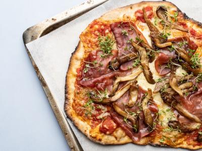 Pizza med tomatsauce, østershatte, bresaola og karse